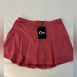 New never worn ziya brand tennis skirt.  Pinkish burgundy color.  Built in short